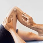 A Physiotherapist treating a patient's knee pain & injury