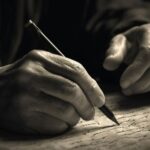 A man is writing a crime statement