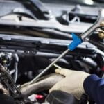 Mechanic fixing car fuel injectors